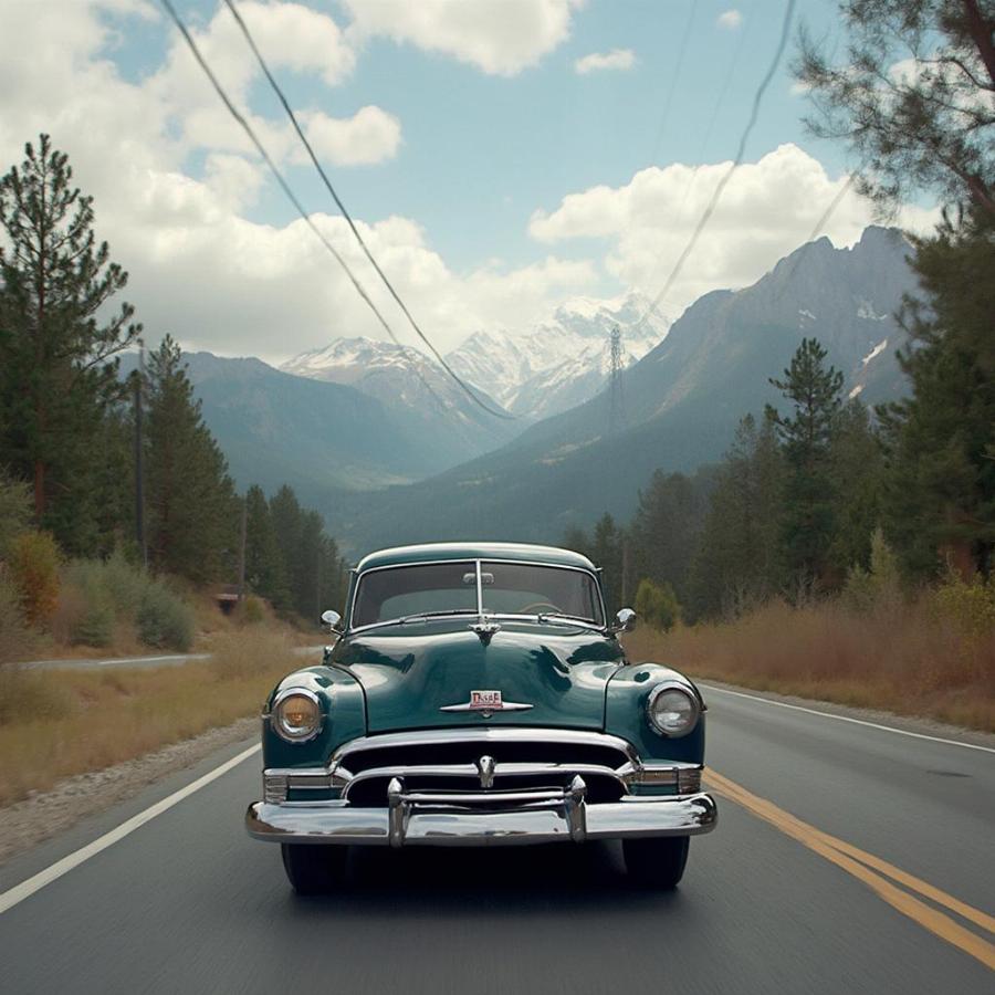 1952 Pontiac Chieftain cruising down a scenic road, highlighting its classic design in motion.