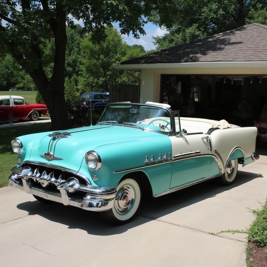 Sleek profile view of a restored 1955 Pontiac Chieftain showcasing its two-tone paint job and iconic chrome details.