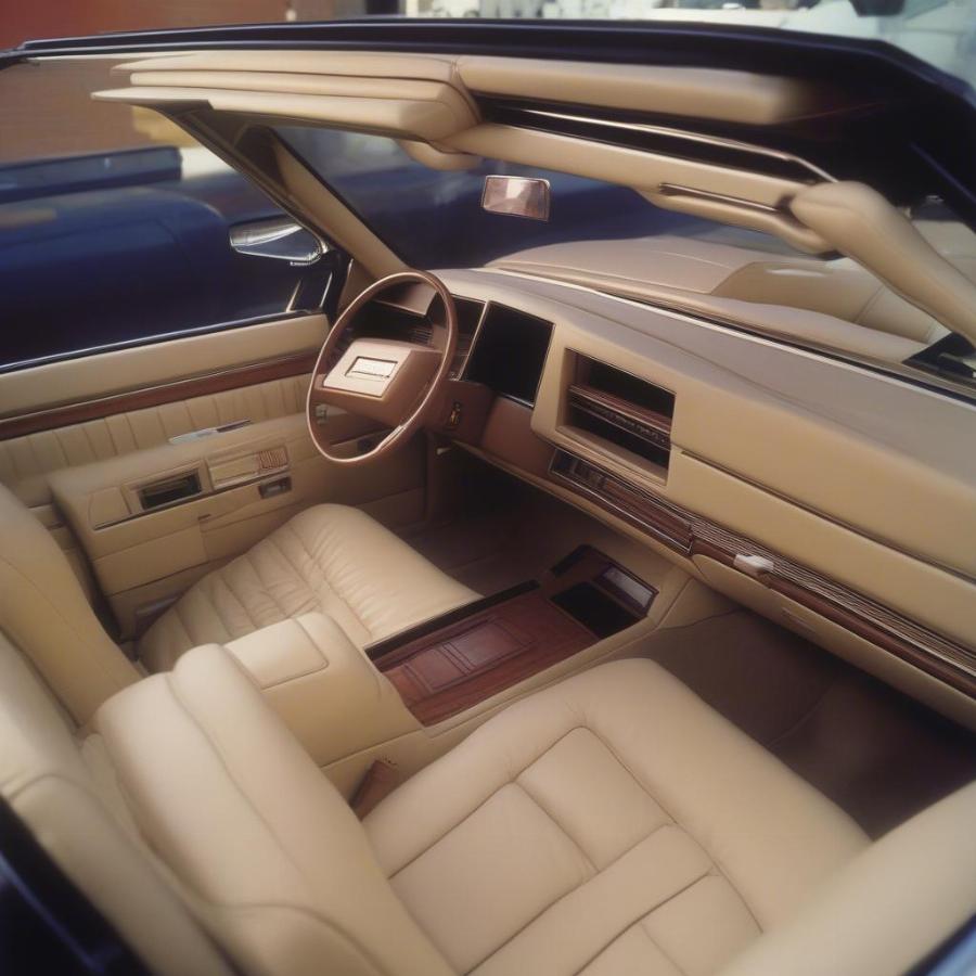 1985 Cadillac Eldorado Biarritz Convertible Interior: Displaying the luxurious leather seats and digital dashboard of this classic car.