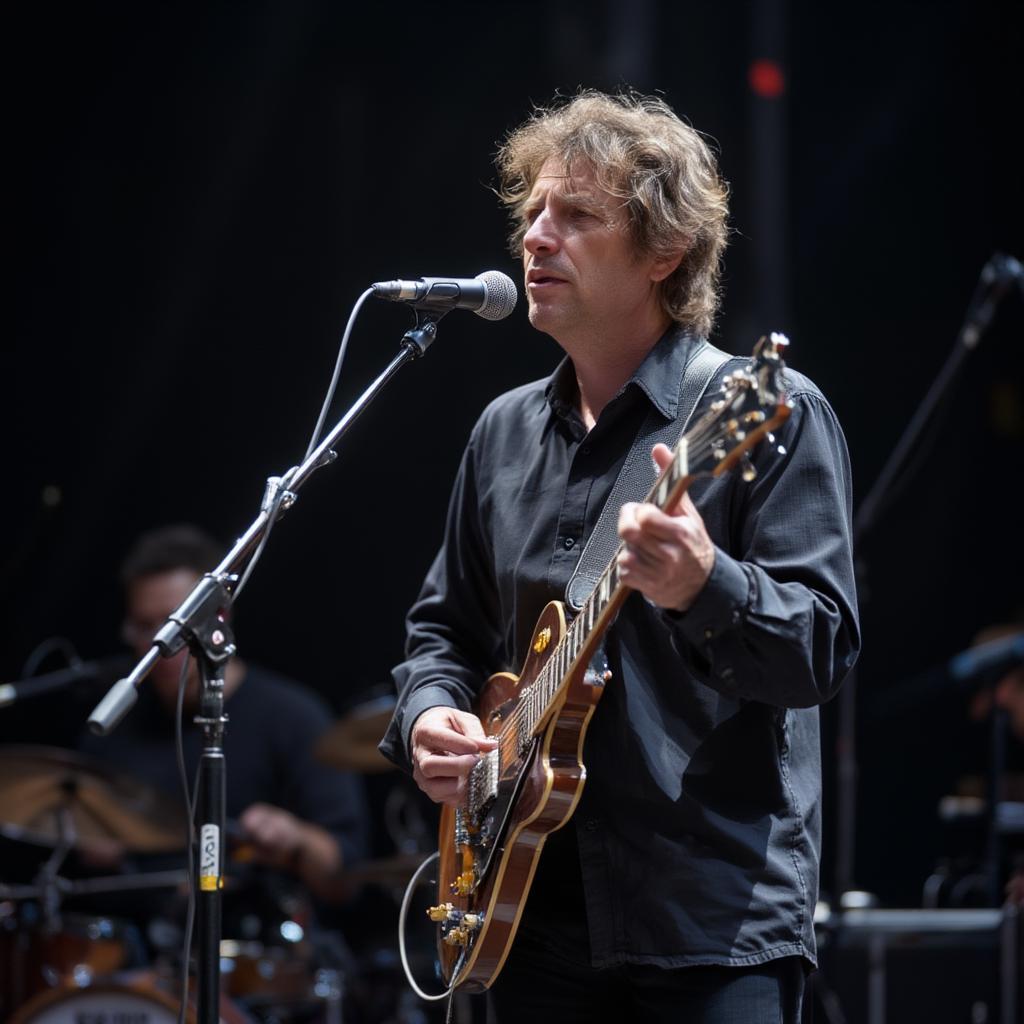 bob dylan performing on stage with an electric guitar