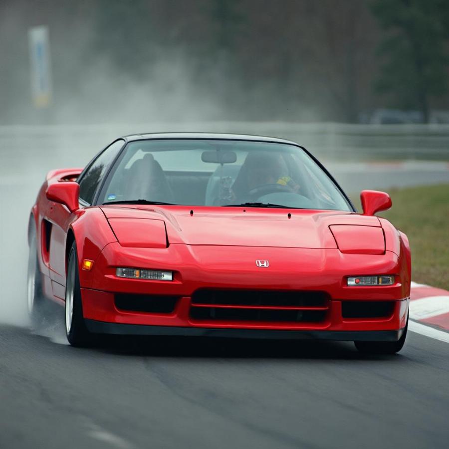 First-generation Honda NSX navigating a race track, demonstrating its performance capabilities.