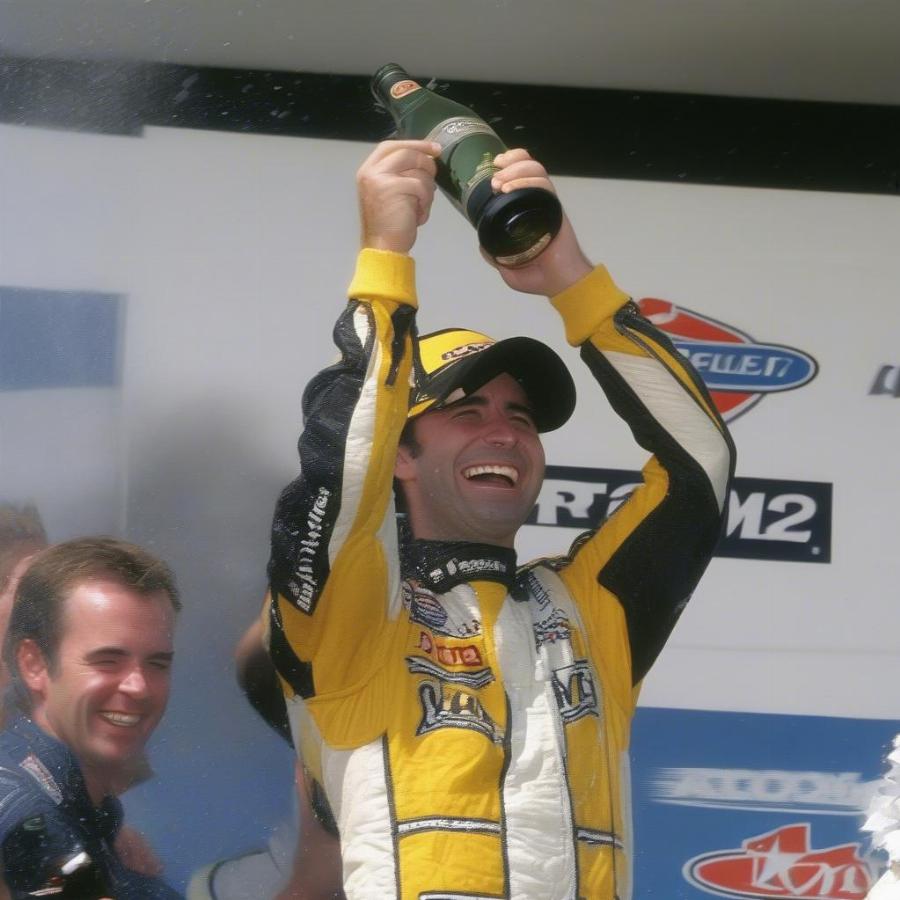 Marcos Ambrose celebrating a podium finish in 2003