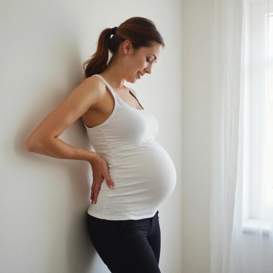 Pregnant Woman Stretching Her Back to Relieve Pain