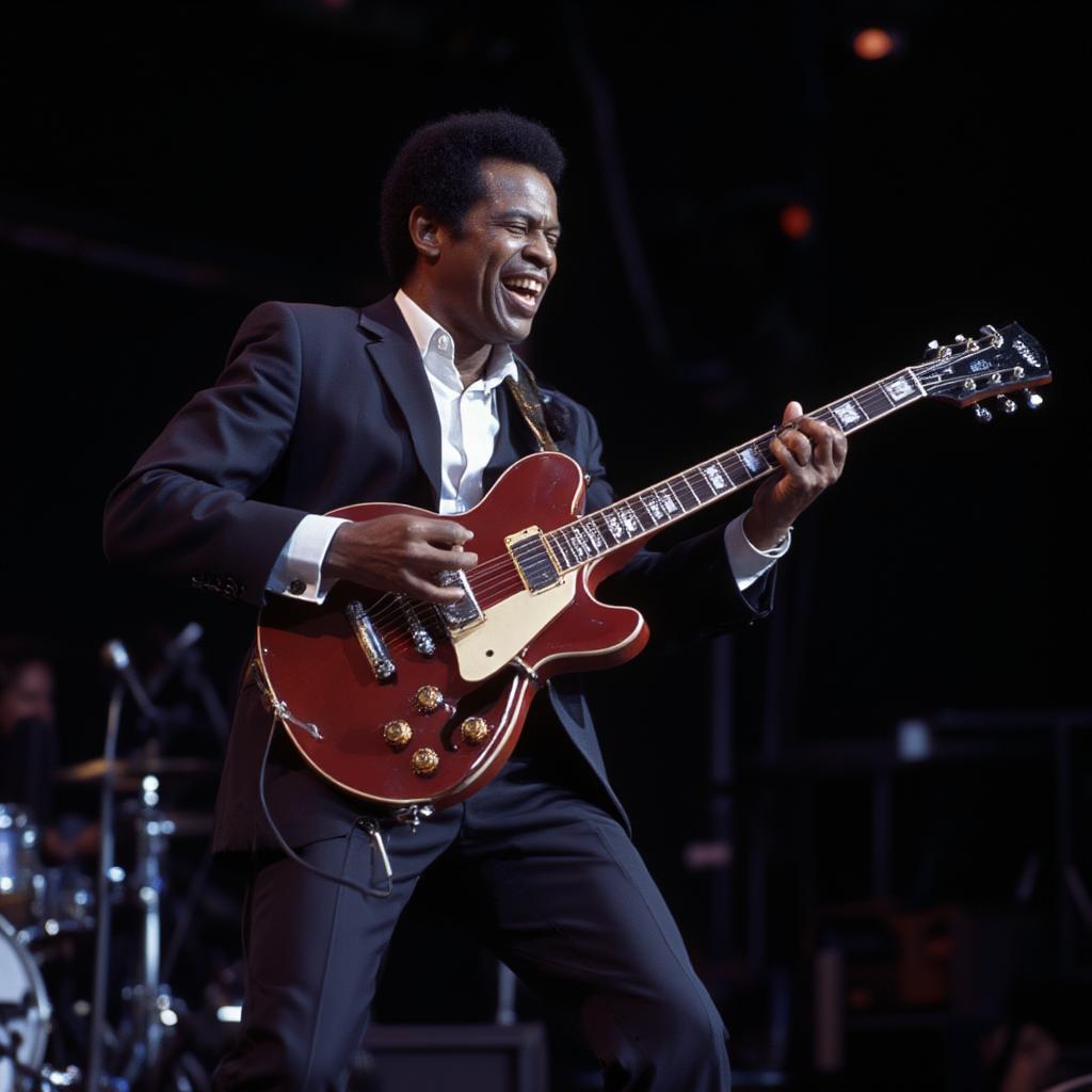 Chuck Berry playing his signature red guitar on stage