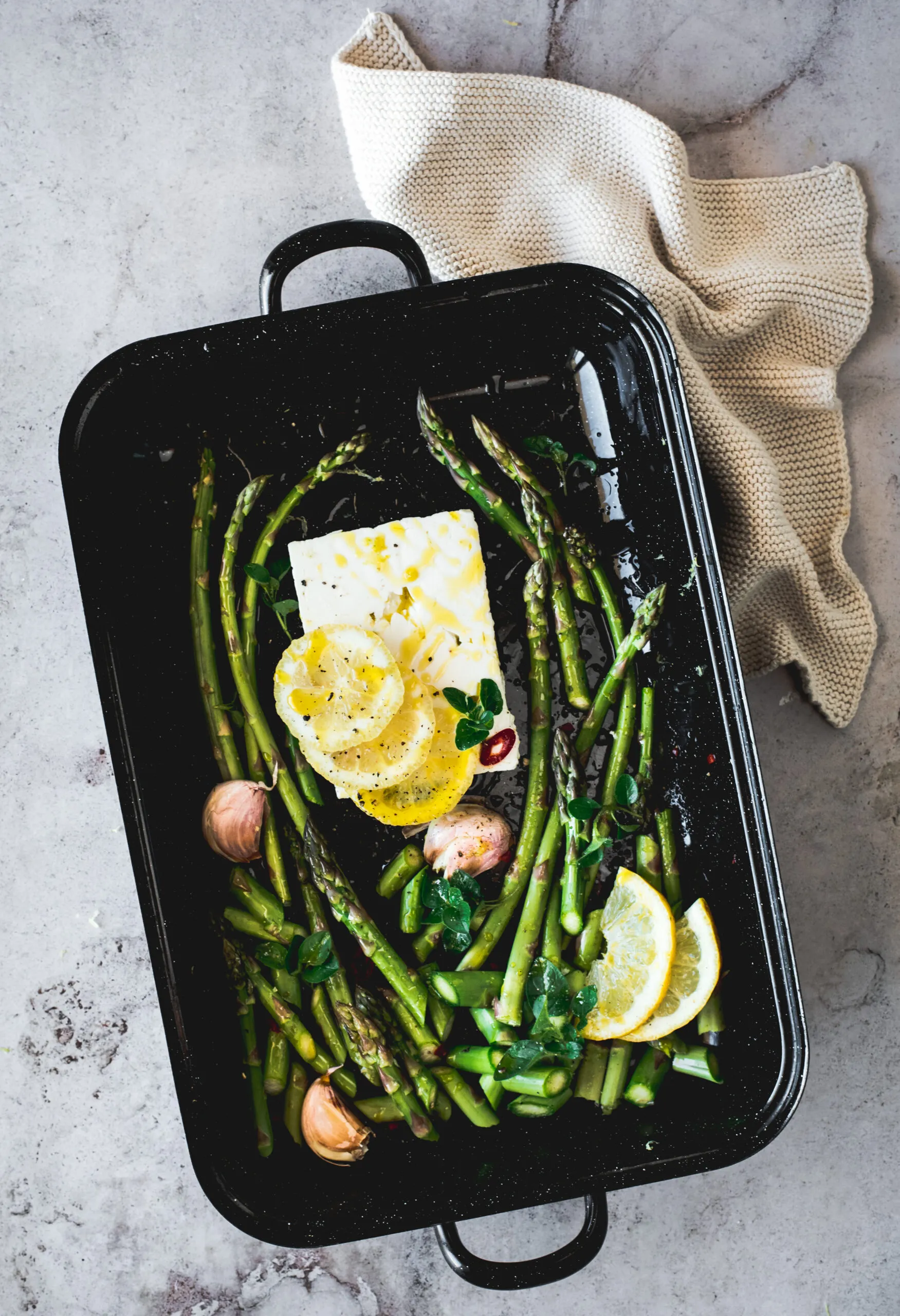 Baking dish with feta &amp; green asparagus - food photo flatlay