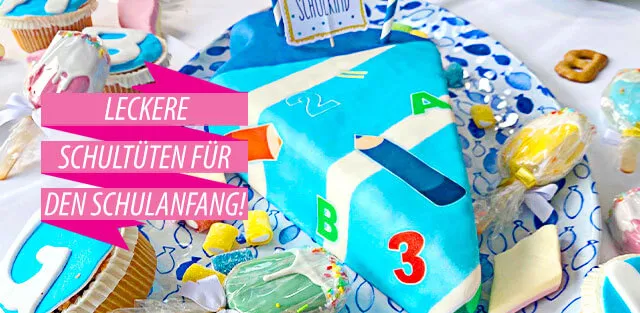 Bunte Einschulungstorte mit Zahlen, Buchstaben und Zuckertüte für den Schulstart
