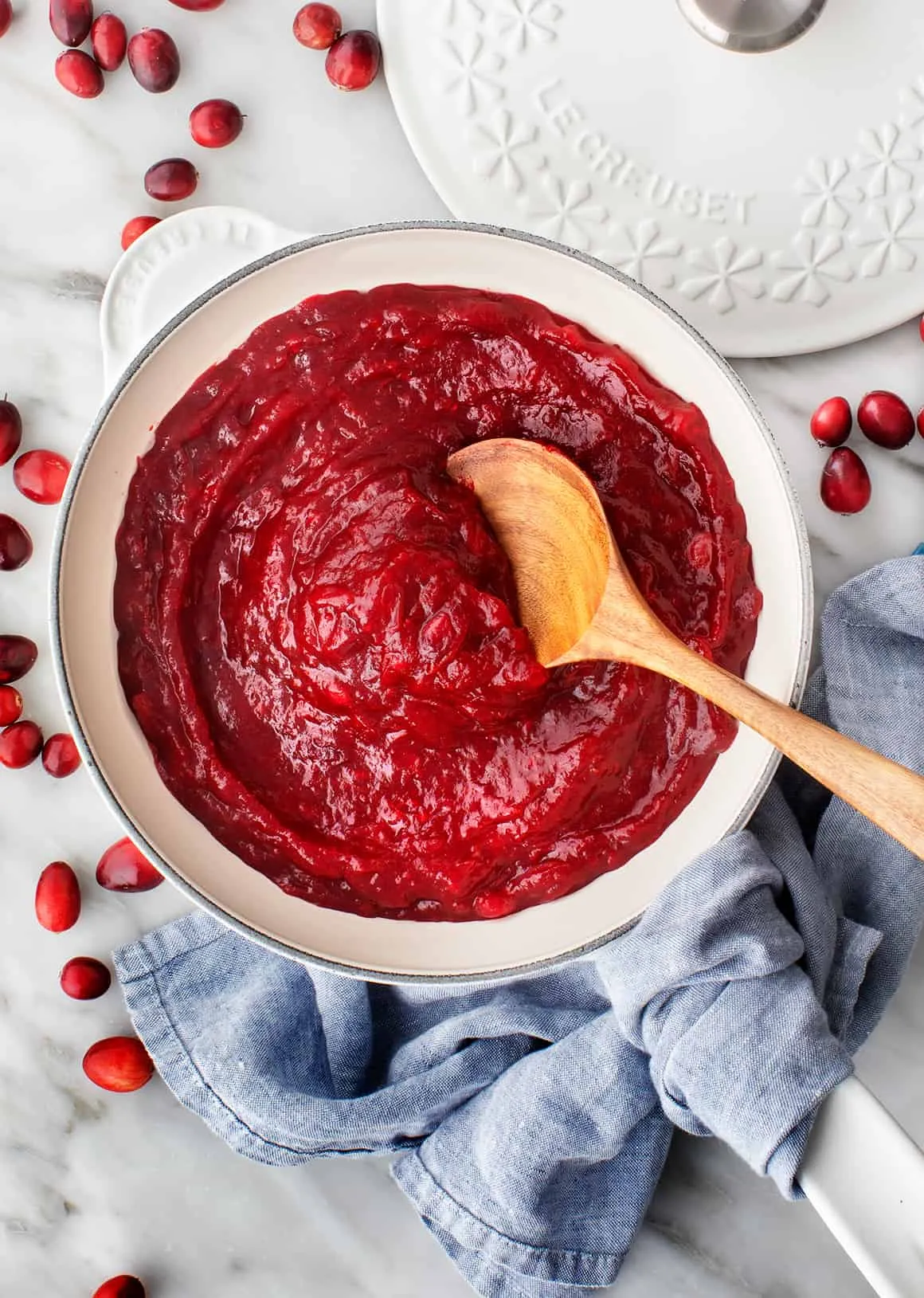 Cranberry Sauce in a saucepan with wooden spoon
