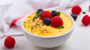 Cremige Polenta mit frischen Beeren, garniert mit Sesam und Nüssen