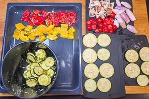 Das Gemüse mit der Soße verrühren und darauf achten, dass Zucchini und Champignons zuletzt drankommen. danach kommt alles auf das Backblech.