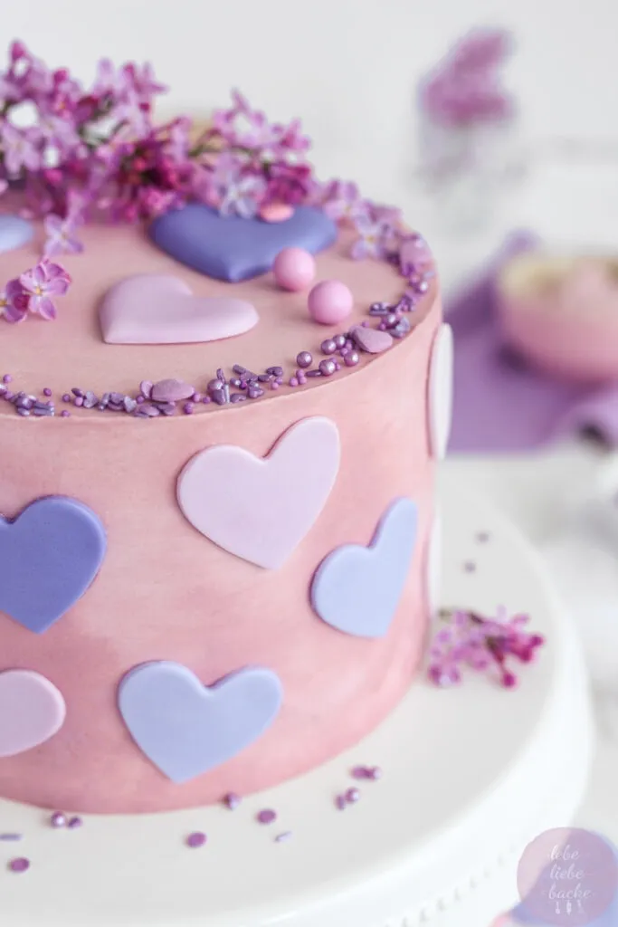 Detailansicht der Buttercreme-Dekoration auf einer Käse-Sahne-Torte mit Fliederblüten