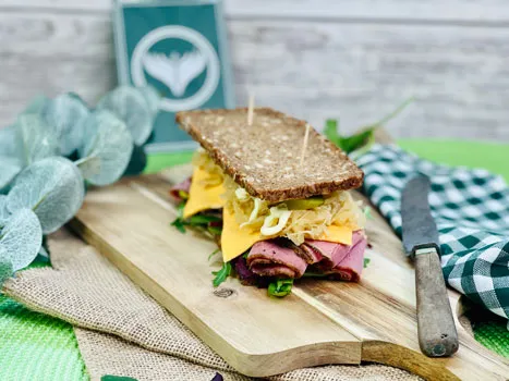 Ein Pastrami-Sandwich mit Salat und Gurken, ideal als Snack für unterwegs