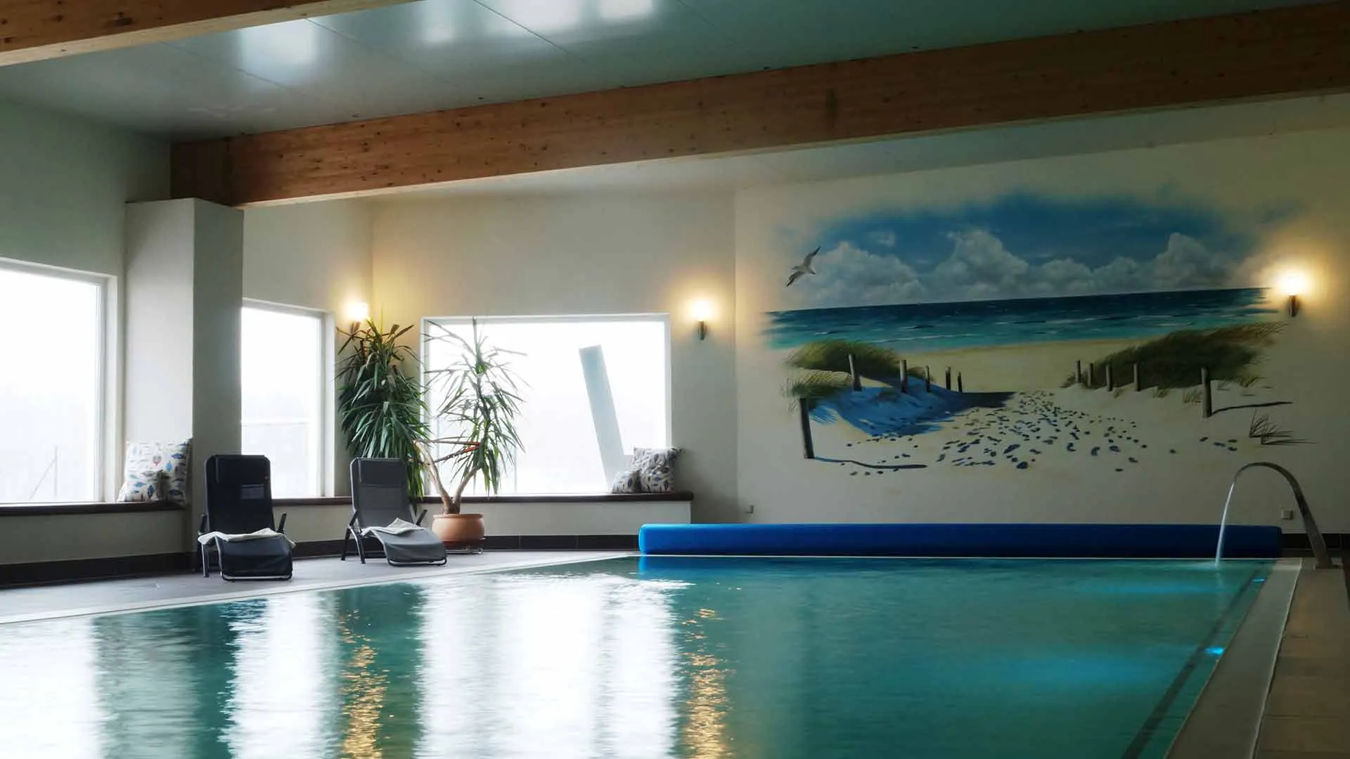 Einladendes Hallenbad mit blauem Wasser und Tageslicht, perfekt für einen entspannten Tag mit der Familie
