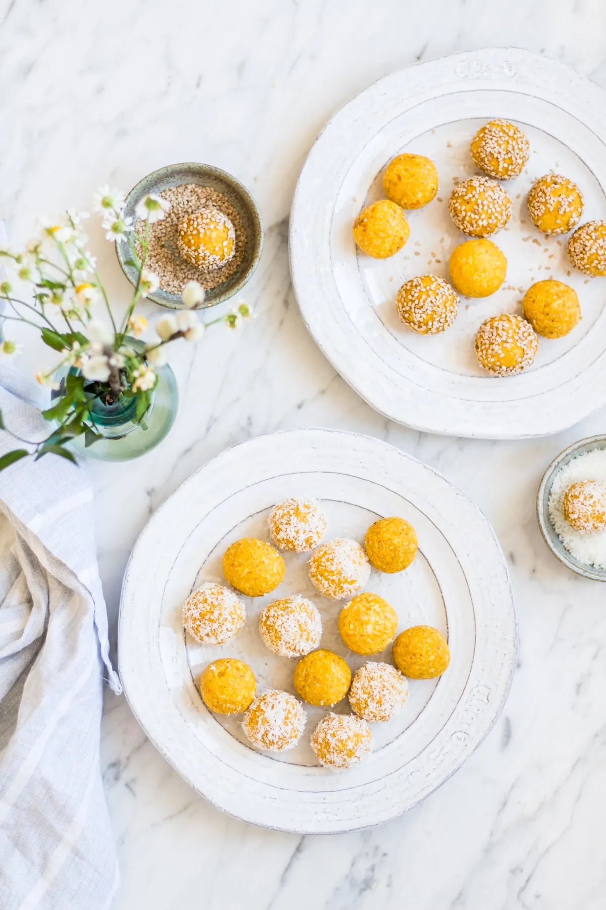 Exotische Mango Kokos Energy Balls, hergestellt aus getrockneten Mangos, Kokosflocken und Cashewkernen, ideal als schneller Snack.