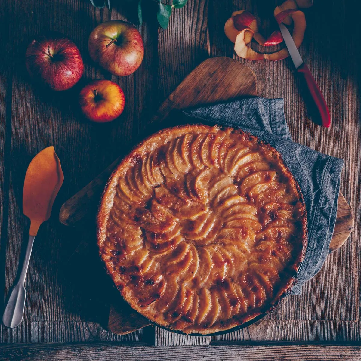 Frische Apfelspalten kunstvoll auf eifreiem Teig arrangiert