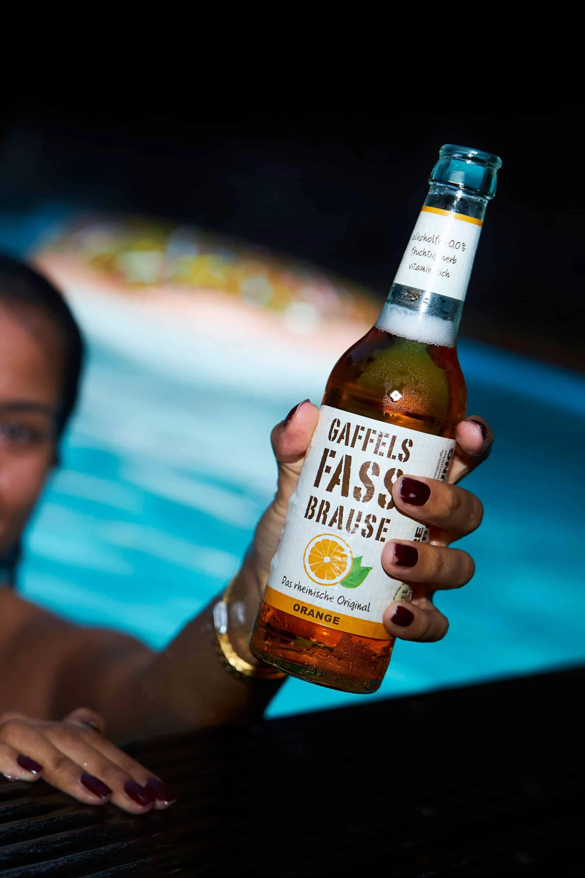 Gaffels Fassbrause Orange: Erfrischendes Getränk im Poolambiente für sommerlichen Genuss.