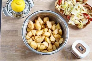 Geschälte und geschnittene Äpfel in einer Schüssel, mit Zimt und Zitronensaft vermengt, bereit zum Kochen