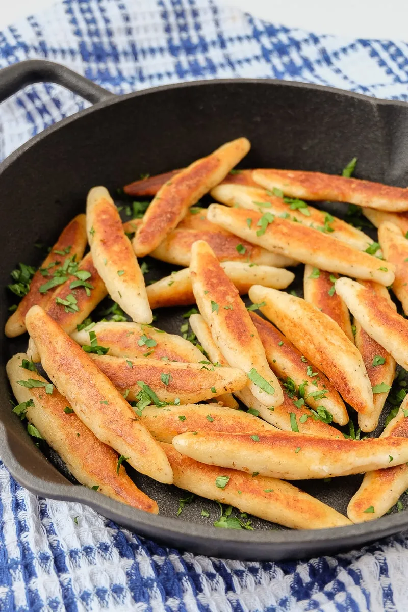 Geschupfte Kartoffelnudeln in einer Gusseisenpfanne, servierfertig.