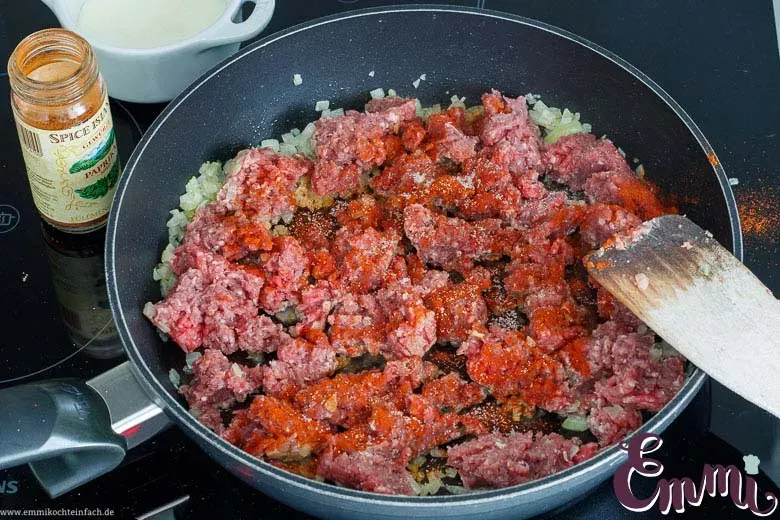 Hackfleisch wird in der Pfanne angebraten und zerkleinert, um die Füllung vorzubereiten