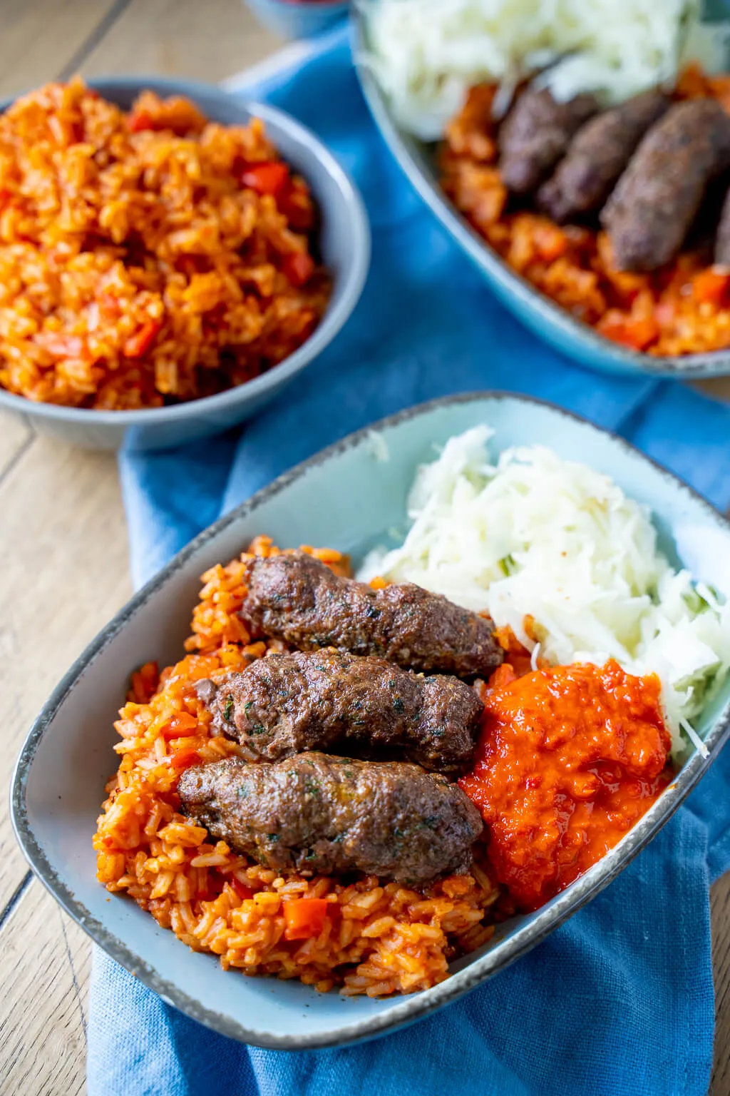 Hausgemachter Djuvec Reis mit saftigen Cevapcici, ideal für ein unkompliziertes Mittagessen