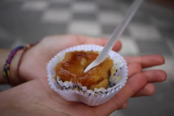 Jemand hält ein Pionono mit einem Löffel darin.