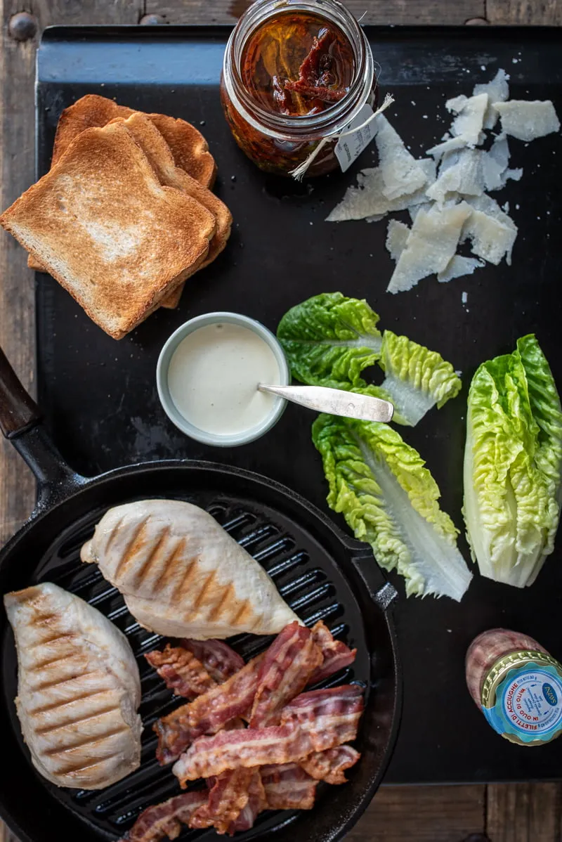 Klassisches Club Sandwich Caesar Style mit Hähnchenbrust und Bacon, in Dreiecke geschnitten