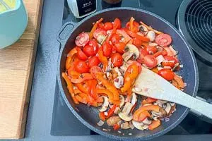 Knoblauch und Tomaten zugeben.