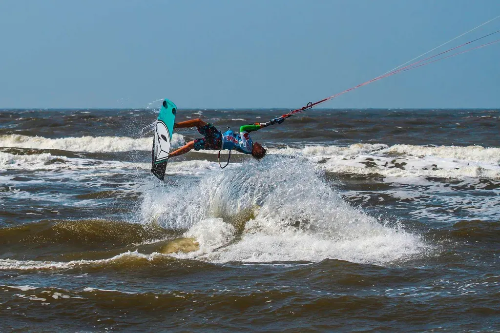 Kytesurfen ist eine beliebte Aktivität für einen Strandurlaub im Deutschland. Das Bild zeigt einen Kytesurfer im Backflip-