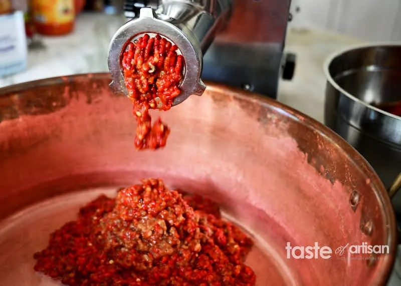 Mahlen der gerösteten Paprika und Auberginen.