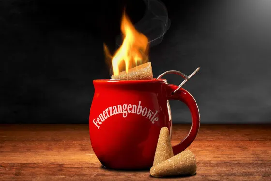 Original Feuerzangentasse gefüllt mit Rotwein und Gewürzen, bereit für das Anzünden des Mini-Zuckerhuts, perfekt für ein individuelles Feuerzangenbowle Rezept