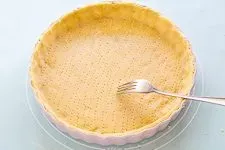 Quiche Teig Boden mit Gabel einstechen, um Blasenbildung zu vermeiden.