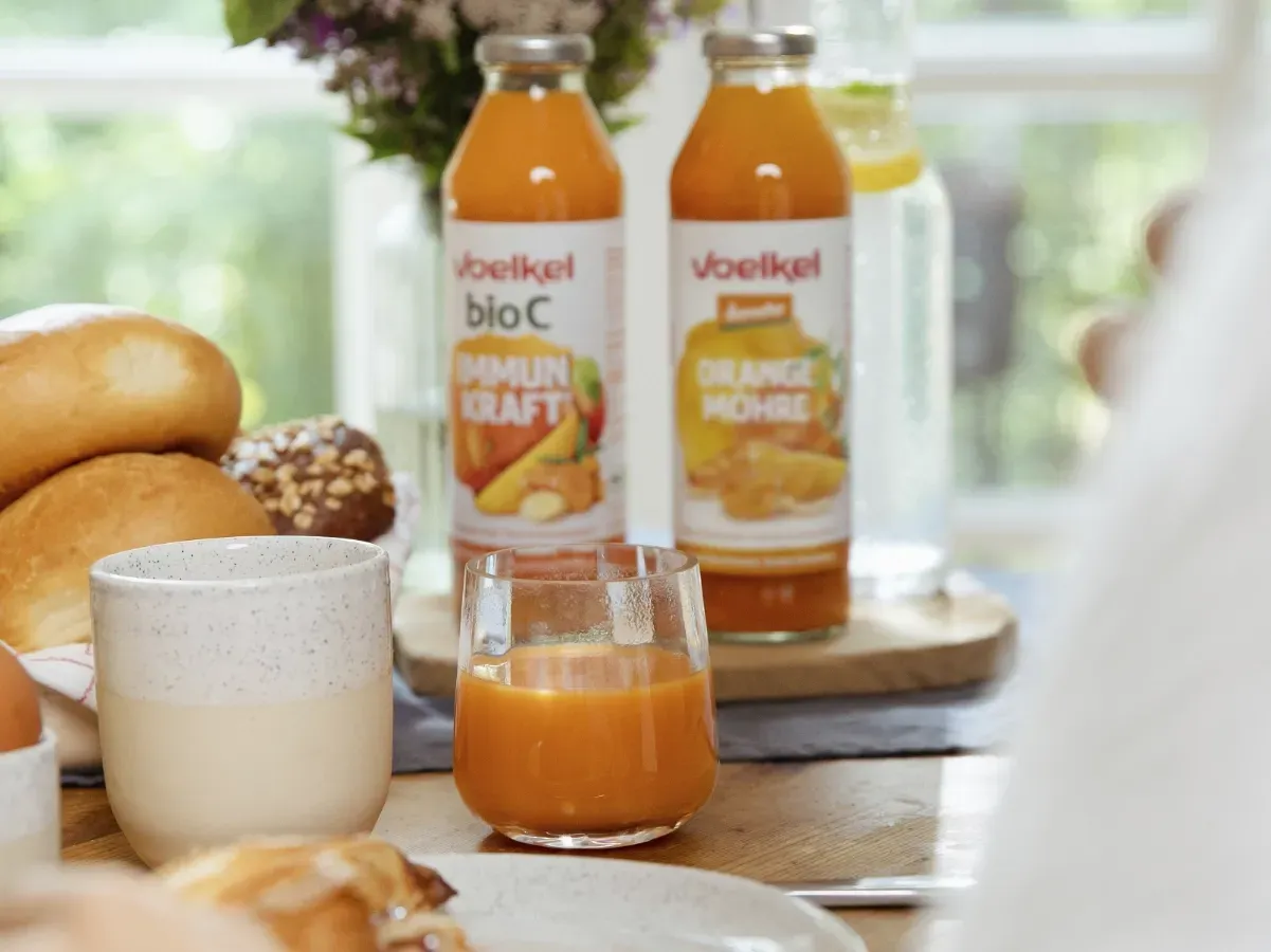 Regal voller Voelkel Fruchtsäfte und Nektare in verschiedenen Flaschengrößen