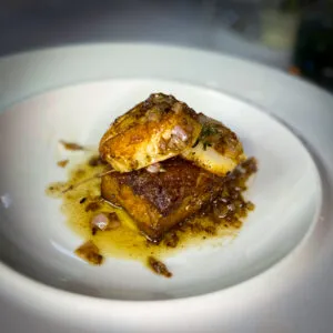 Saisonale Spezialität: Gebratener Schweinebauch mit Jakobsmuscheln im Cochon Restaurant