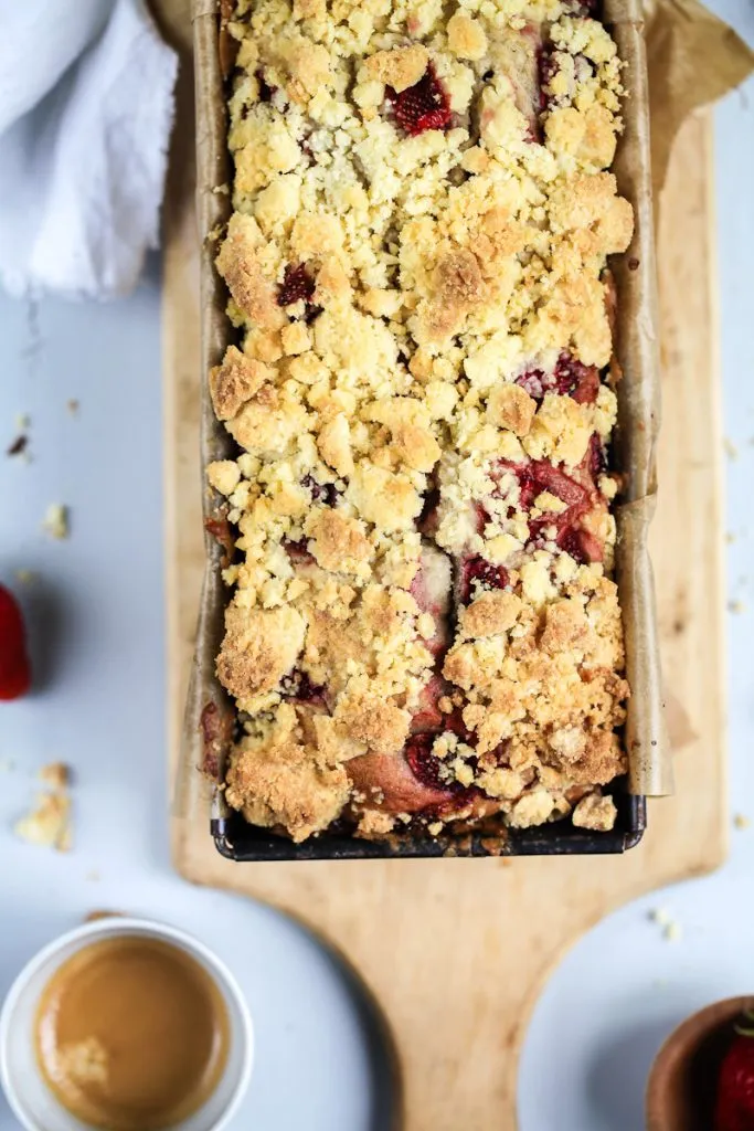 Serviertes Erdbeer-Bananenbrot mit Puderzucker und frischen Erdbeeren, ein Genussmoment voller Zucker, Zimt und Liebe