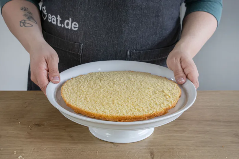 Unterer Tortenboden auf Tortenplatte platzieren