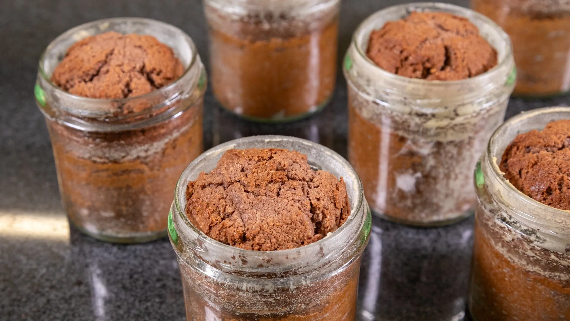 Die fertig gebackenen Kuchen im Glas müssen nun schnell verschlossen werden, damit das Vakuum entsteht und die Kuchen für ein halbes Jahr haltbar sind.