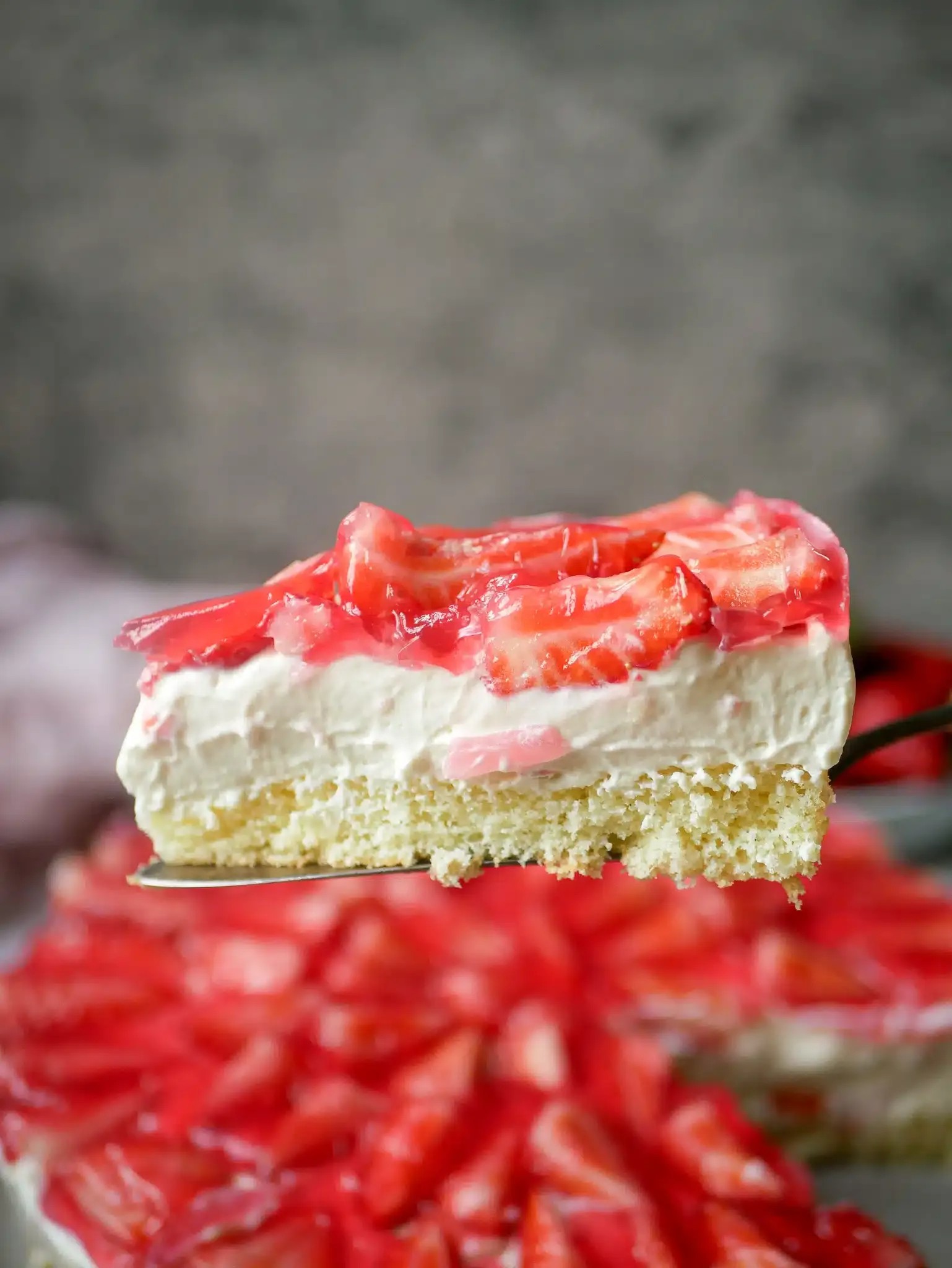 Erdbeerkuchen mit Schmand und frischen Erdbeeren auf einer Tortenplatte