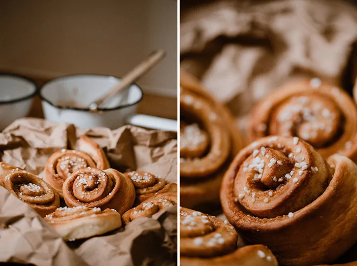 Frisch gebackene Zimtschnecken mit goldbrauner Kruste und Hagelzucker auf einem Backblech, direkt aus dem Ofen.