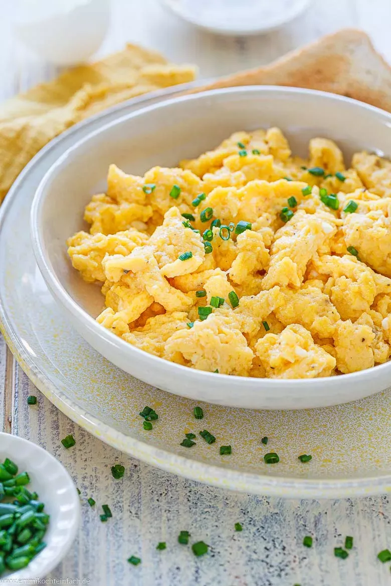 Hausgemachtes Rührei mit frischen Kräutern in einer Pfanne