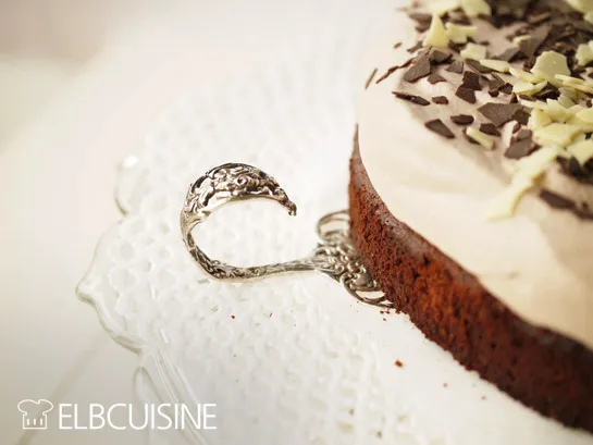 Nahaufnahme eines Löffels, der ein Stück Amarettini-Schoko-Sahne-Torte serviert