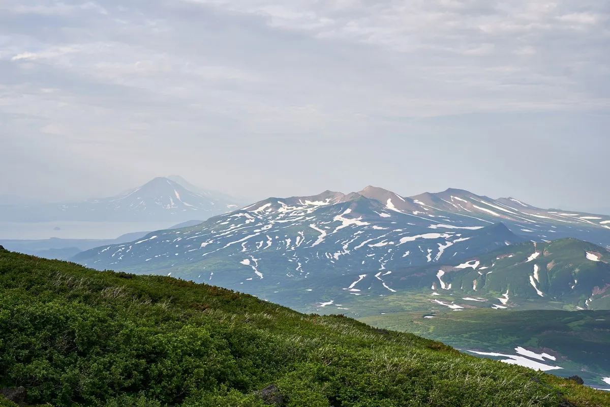 Spektakuläre Sonnenuntergangsbeleuchtung über dem Kurilensee und Ilinsky Vulkan