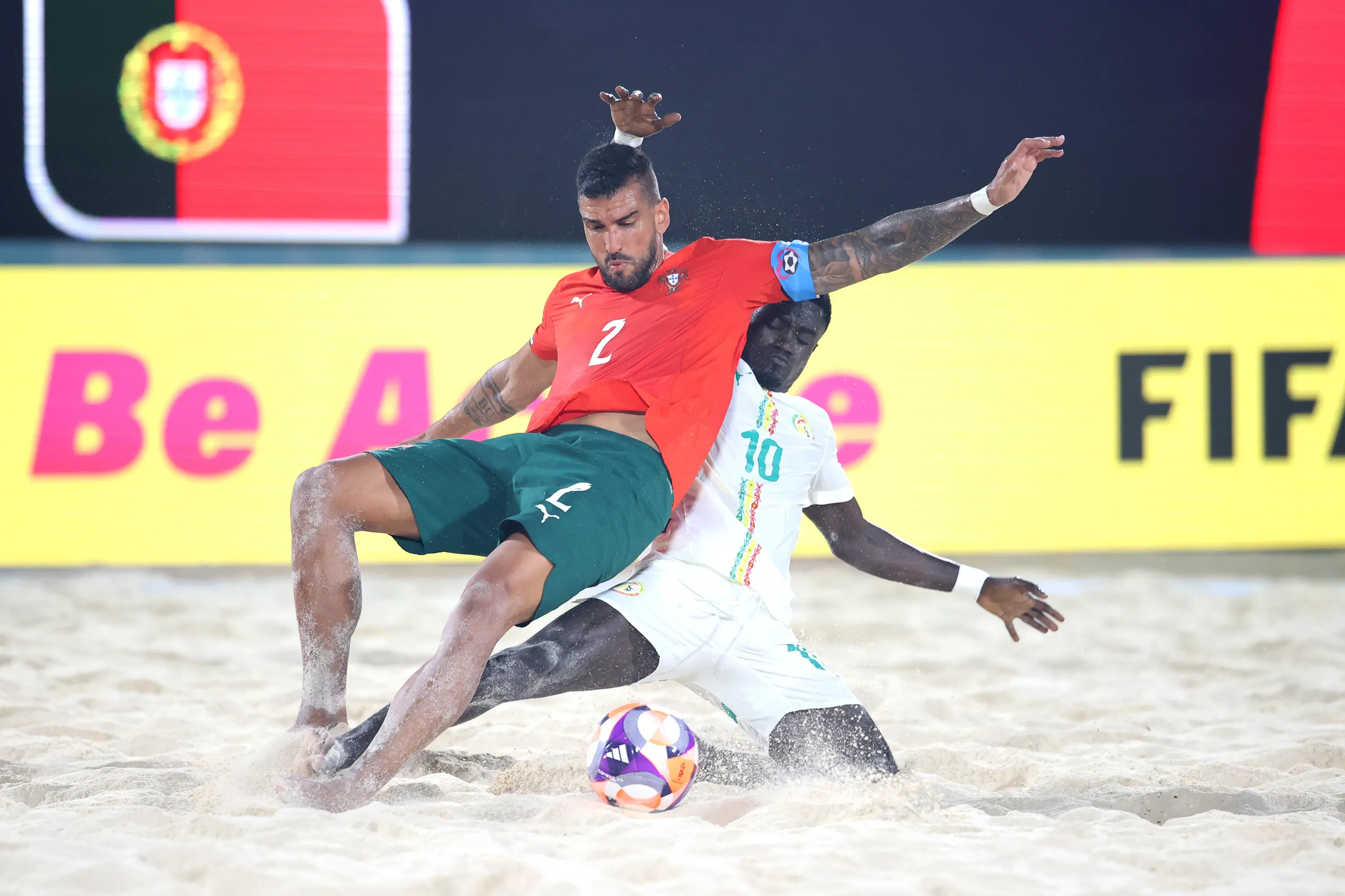 Coimbra of Portugal is challenged by Mamour Diagne of Senegal
