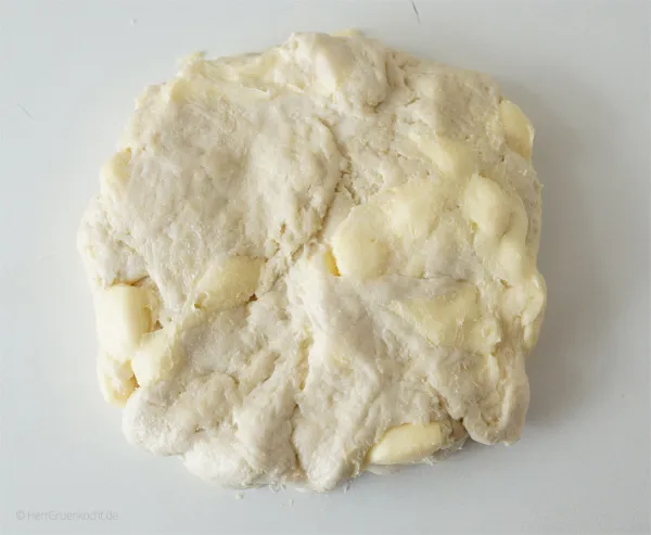 Den vorbereiteten Blätterteig auf einer bemehlten Arbeitsfläche kneten