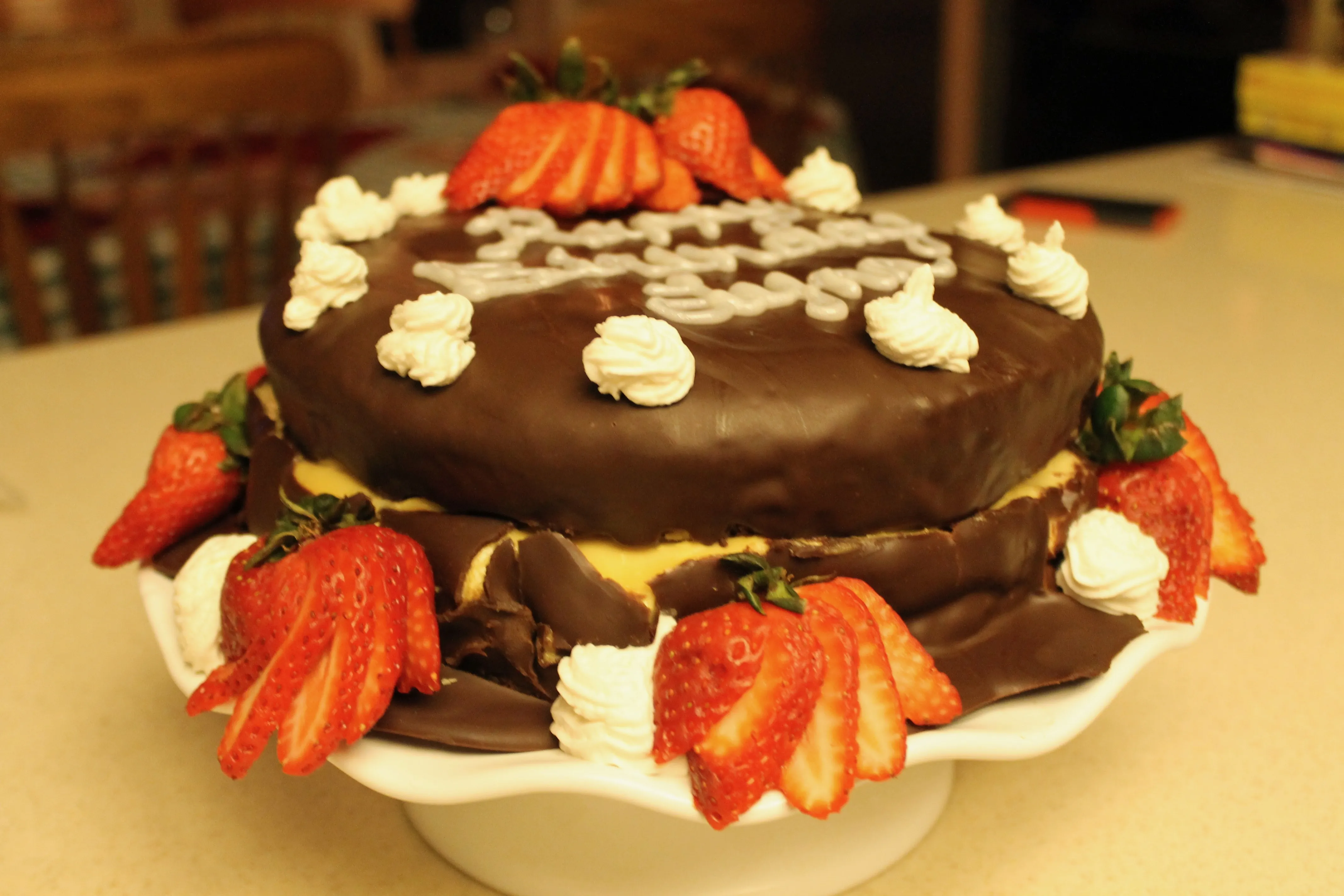 Die fertige, dekadente Brownie-Torte mit Kahlúa-Sahnetupfen und sichtbarer Gebäckcreme zwischen den Schichten