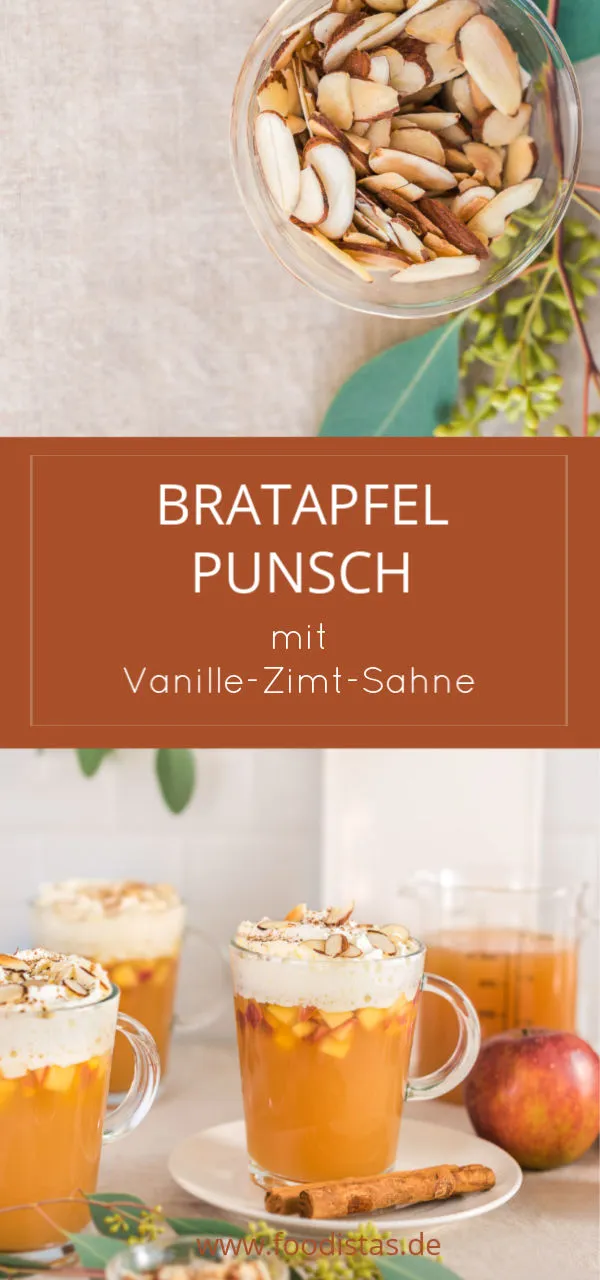 Ein Glas Bratapfelpunsch mit aufgeschlagener Sahne und Zimt