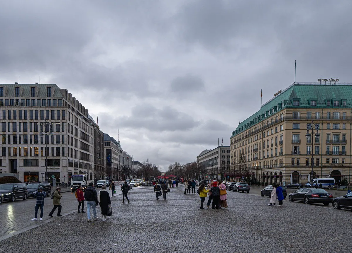 Ein Passant geht vor dem verhüllten Brandenburger Tor entlang