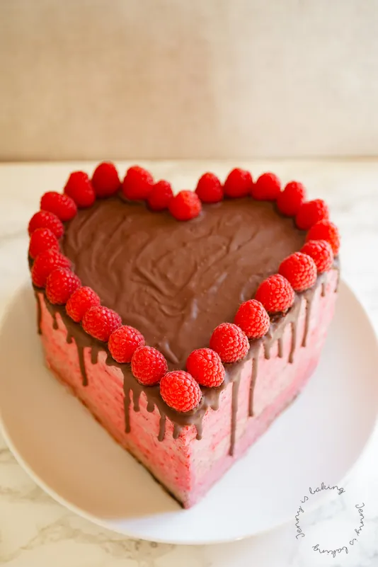 Eine runde Torte, die in zwei Teile geschnitten wird, um die Form eines Herzens zu erhalten