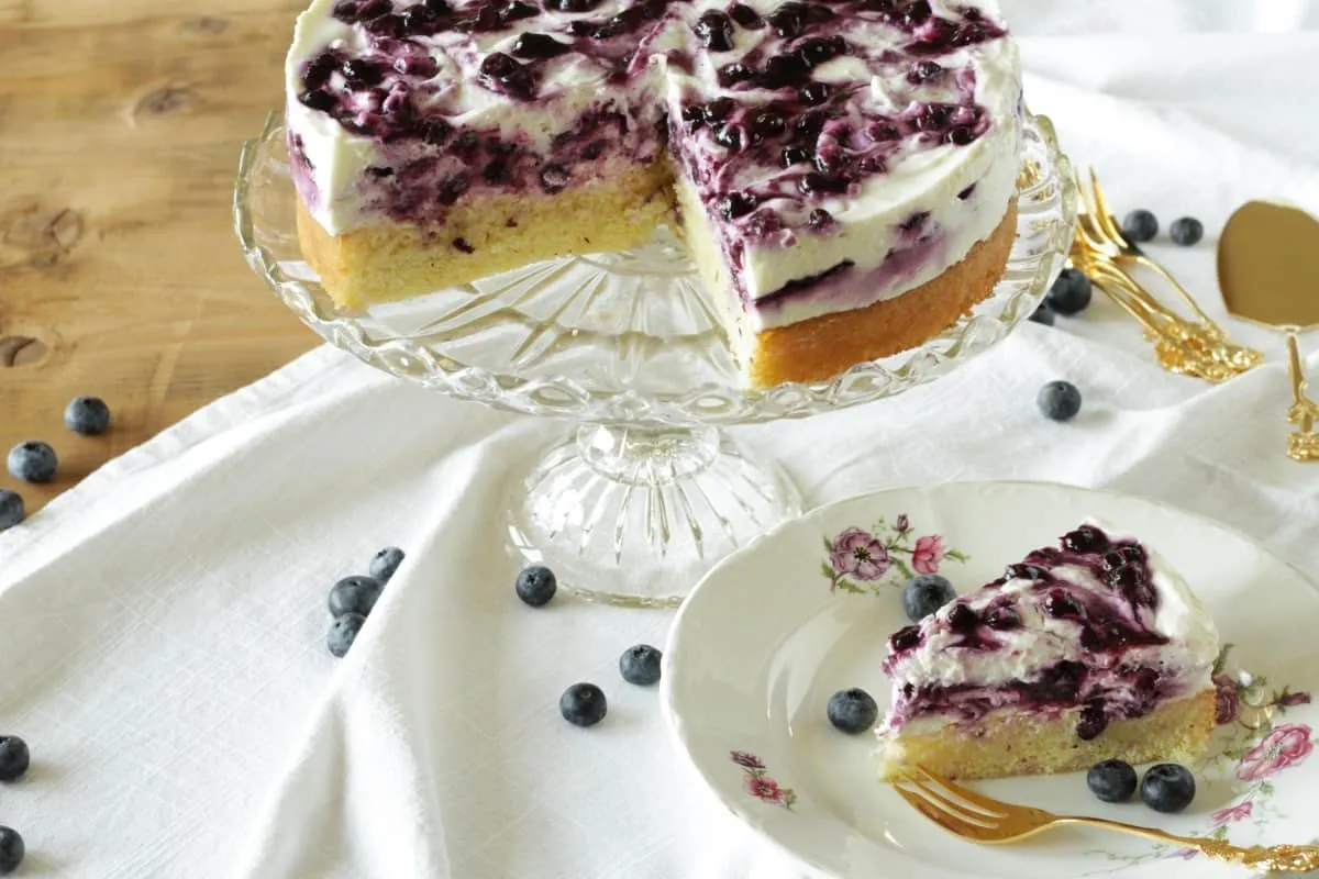 Eine wunderschön angerichtete Blaubeer-Quark-Torte mit Blaubeerswirl