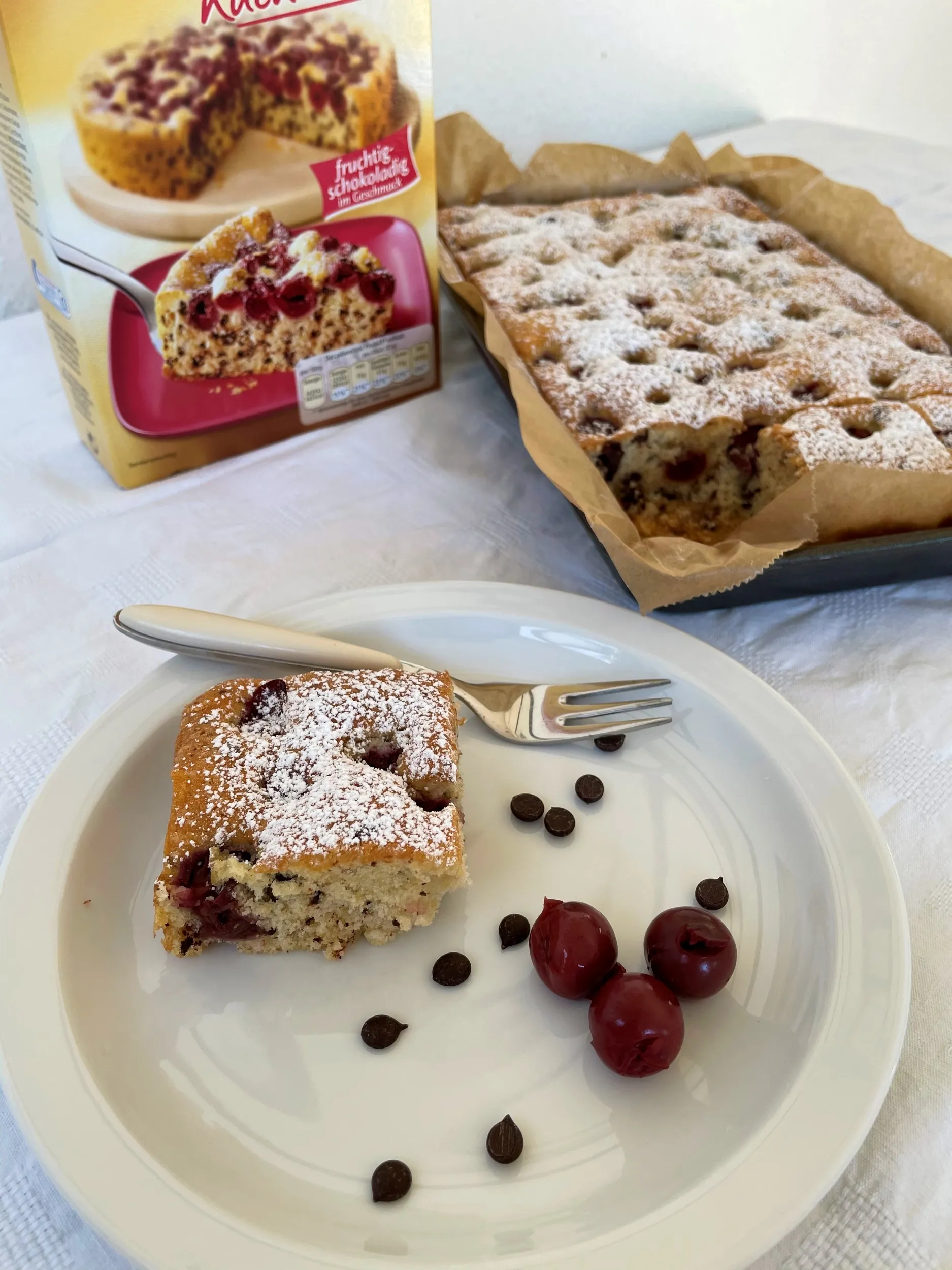Kirsch-Schokoladen-Blechkuchen mit Puderzucker bestäubt