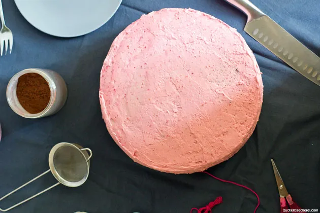 Nahaufnahme einer Schoko-Himbeer-Torte mit Schichten aus dunklem Kuchen und rosa Creme