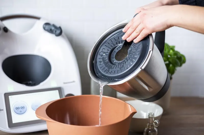 Reis wird im Garkorb abgegossen.